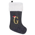 Close-up of grey velvet Christmas stocking with golden glitter G and faux fur trim - Letter G