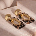 Detail view of leopard print resin earrings with golden metal geometric accents - Leopard Print Rectangular Style (Silver Pin)