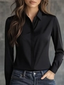 Close-up of elegant black satin long-sleeve shirt with glossy finish and lapel collar - Black
