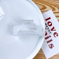 Minimalist square hollow hair claw clip in matte white finish on ceramic plate - Jelly White