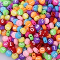 Close-up of colorful round acrylic beads featuring white printed numbers 0-9 for DIY - 4x7mm Deep Colored With White Numbers (100pcs)