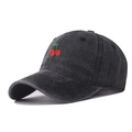Close-up of embroidered red cherries on a vintage washed grey cotton baseball cap - Black