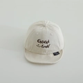 Close-up of beige cotton baby cap with Good Luck embroidery and smiley face detail - 50cm (Recommended 1-3 Years) / Beige (Good Luck Smiley)