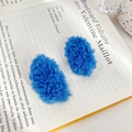 Set of two vibrant blue plush hair clips in soft faux lamb wool on a book background - 5cm / Klein Blue 2Pcs