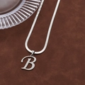 Silver hip hop necklace featuring a letter B pendant on a smooth herringbone chain - Letter B
