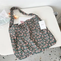 Detail of vintage floral corduroy tote bag with soft inner texture and brand tag - Kerria Pink