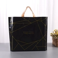 Detail of a black plastic shopping bag with gold geometric patterns and elegant handles - 33x25cm+Bottom 3cm / Black