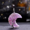 Macro shot of purple amethyst crescent moon pendant with silver tree of life wire wrapping - Amethyst