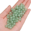 Polished green glass beads for DIY necklaces being held in hand, 6-8mm round size - Aventurine Jade approx 50pcs/pack