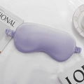 Soft lavender silk sleeping mask with elastic strap shown on a white textured background - Light Blue