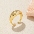 Detail of gold croissant ring with white zircon inlay on a textured stone surface - Adjustable Open / Gold Zirconia Croissant