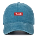 Detailed embroidery of white Hustle text on red patch on washed blue cotton baseball cap - One Size / Lake Blue
