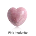 Polished 15mm pink rhodonite heart-shaped crystal stone on white background - Rhodonite