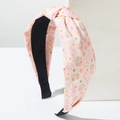 Detailansicht des rosa Oster Stirnbands mit Eier-Print und Knotendesign aus Stoff - Rosa