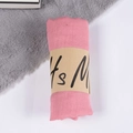 Pink cotton linen scarf rolled with kraft paper band on soft plush grey carpet - Blood Bud / One Size