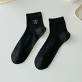Black cotton crew socks with white bow embroidery and vertical ribbed texture for women - One Size / Black