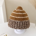Detailed view of striped winter knit hat with cozy pom pom and thick ribbed brim texture - 2-5 Years Old / Caramel color