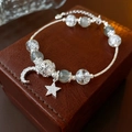 Detail of silver star and moon charms on crystal beaded bracelet over leather - Alloy Star Moon Zirconia Crystal Bracelet