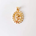 Close-up of golden oval pendant featuring a rose relief and pearl border detailing - Shell Pearl Rose*Gold