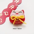 Detail view of 4x5cm plush Japanese cat charm with embroidery and golden bell accent - Fortune Cat