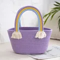 Close-up of purple woven handbag with rainbow handles and boho cotton tassels - Purple