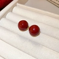 Close-up of elegant deep red spherical stud earrings with high gloss finish on white box - Glossy Round Ball Minimalist Style (52# Silver Earring Post-Gold-Red)