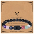 Macro view of Scorpio beaded bracelet with natural obsidian on themed display card - Scorpio