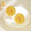 Daisy flower earrings in gold finish with orange-pink center stone on white display - French Vintage Cat Eye Daisy