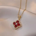 Elegant gold necklace with red four-leaf clover pendant on beige silk background - Gold Clover Necklace (X1788)