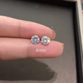 Macro shot of 6mm round cubic zirconia stud earrings with 925 silver needles - 6mm White Zircon 1 Pair