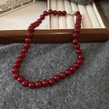 Macro detail of deep red glass beads and silver clasp on a minimalist necklace - 2# Necklace - Red (9mm)