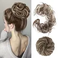 Detail showing a messy bun hair piece in light brown mixed with blonde highlights - 9H613# (Platinum Blonde Mix)