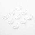 Macro view of ten moon shaped translucent glass charms with hanging holes for DIY jewelry - Frosted White