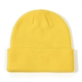 Close-up of vibrant yellow ribbed knit beanie showing soft wool texture and folded cuff - Yellow