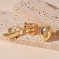 Close-up of three chunky gold rings with mirror-polished finish on natural travertine stone - Gold Oval Bean (3-Pcs Set)