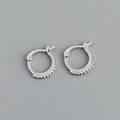 Detail view of silver round hoop earrings with delicate beaded textures on a grey background - Ten Rhinestone Hoop Earrings (S-E1558) / Silver