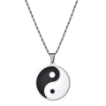 Close-up of yin yang pendant with silver twisted chain on white background - Black and White