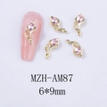 Detail view of 6x9mm gold flower nail charms with pink rhinestones on white backdrop - Gold Base Pink Rhinestone (AM87)