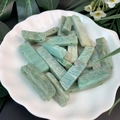 Macro shot of natural sky blue stone bar beads with white veins in a ceramic tray - Amazonite