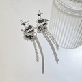 Detail of silver tassel earrings with black heart stones and star charms on white mirror - Black Heart Star Tassel Style (DZ-847)