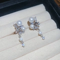Macro detail of star-shaped zircon and pearl drop earrings on beige fabric background - 2# Pearl Star Zirconia Pendant Earrings - Silver - Pair