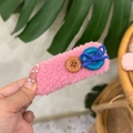 Handheld pink plush hair clip with buttons and a blue bow detail, soft aesthetic - Rose Pink - Blue Button