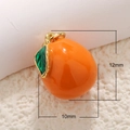 Macro view of orange fruit charm with enamel finish measuring 12mm by 10mm in size - Persimmon