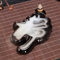 Brown ceramic backflow incense burner with zen smoke flow on bamboo mat - Quietness