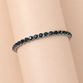 Detailed view of tennis bracelet featuring deep blue round-cut crystals in silver claw settings - 18cm / Navy Blue