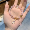 Pink beaded bracelet featuring gold accents and StellaLou cartoon charm on a wrist - S020-pink Stellalou Bursting Flower Bracelet #sz082
