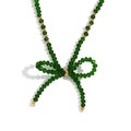 Green faceted crystal bead necklace with gold accents in a stylish bow design - Emerald Green Transparent
