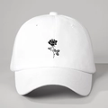 Close-up of a white baseball cap featuring detailed black rose floral embroidery - One Size / White