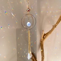 Golden moon suncatcher with crystal facets creating colorful rainbow light spots on a wall - B17 Style