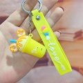 Close-up of bright yellow silicone milk tea cup keychain with love strap and metal ring - Ice Cream Cup / Yellow